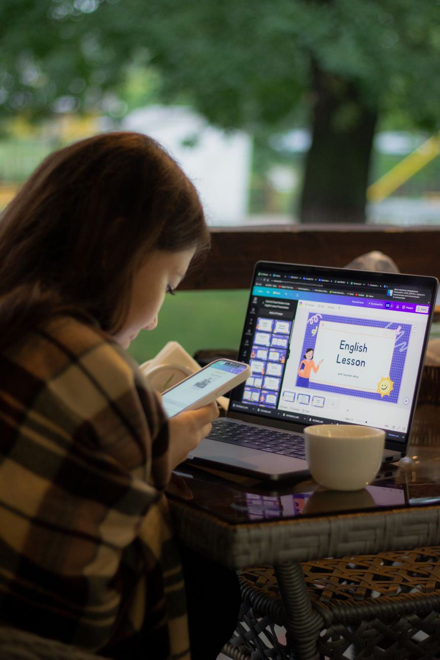 Woman using a laptop for an online language lesson, illustrating AI translation tools