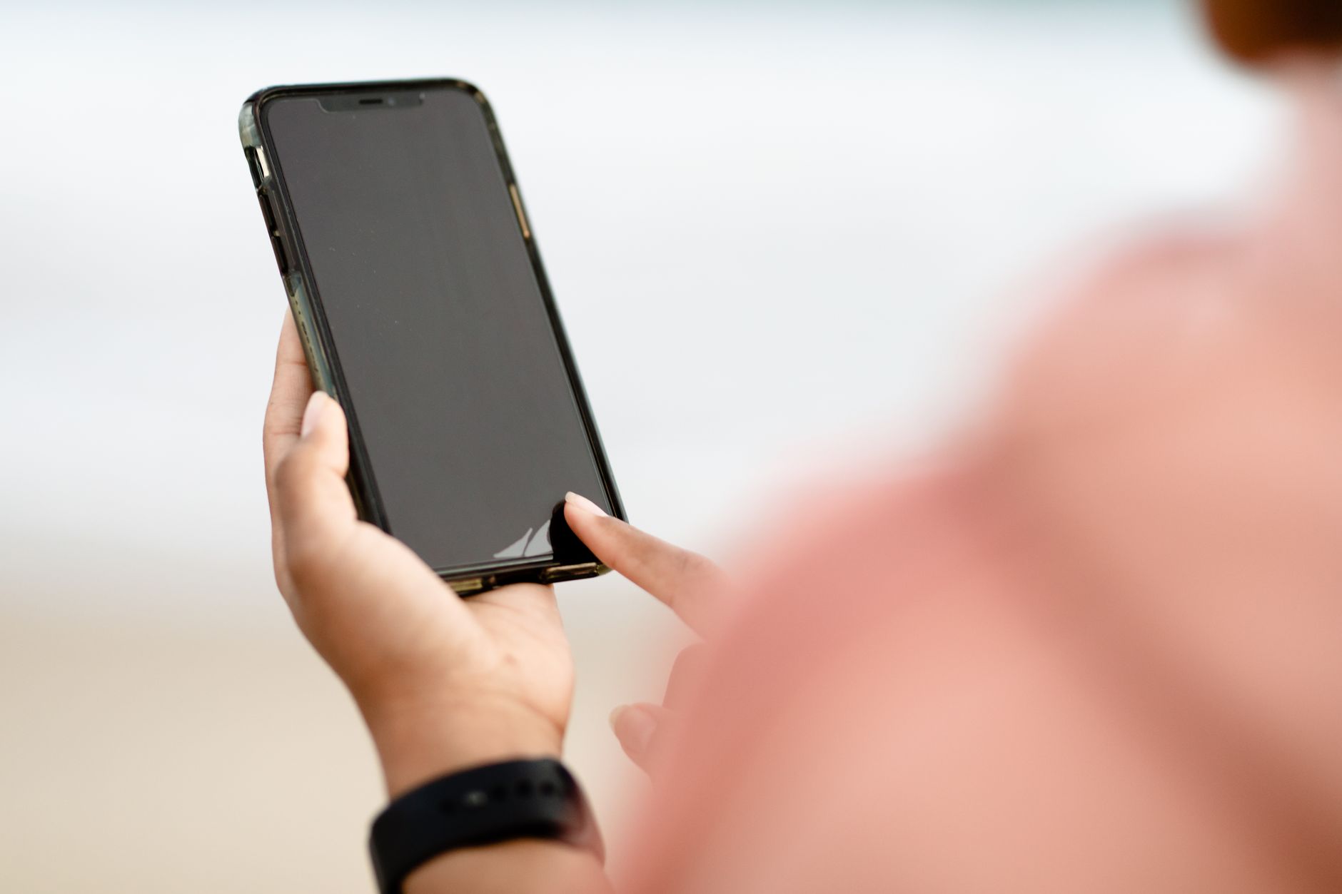 Person holding a smartphone, using AI features on their phone for everyday tasks