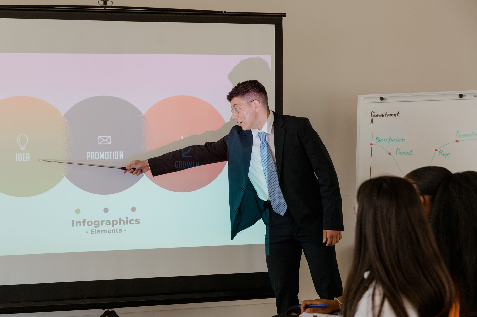 Presenter pointing at a bright slide during a business presentation