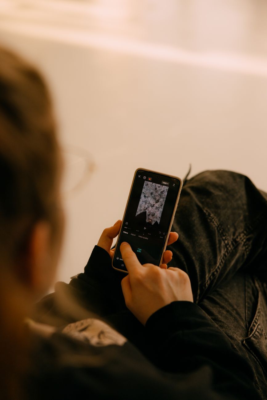 Person using a smartphone to edit a photo with AI photo editing tools