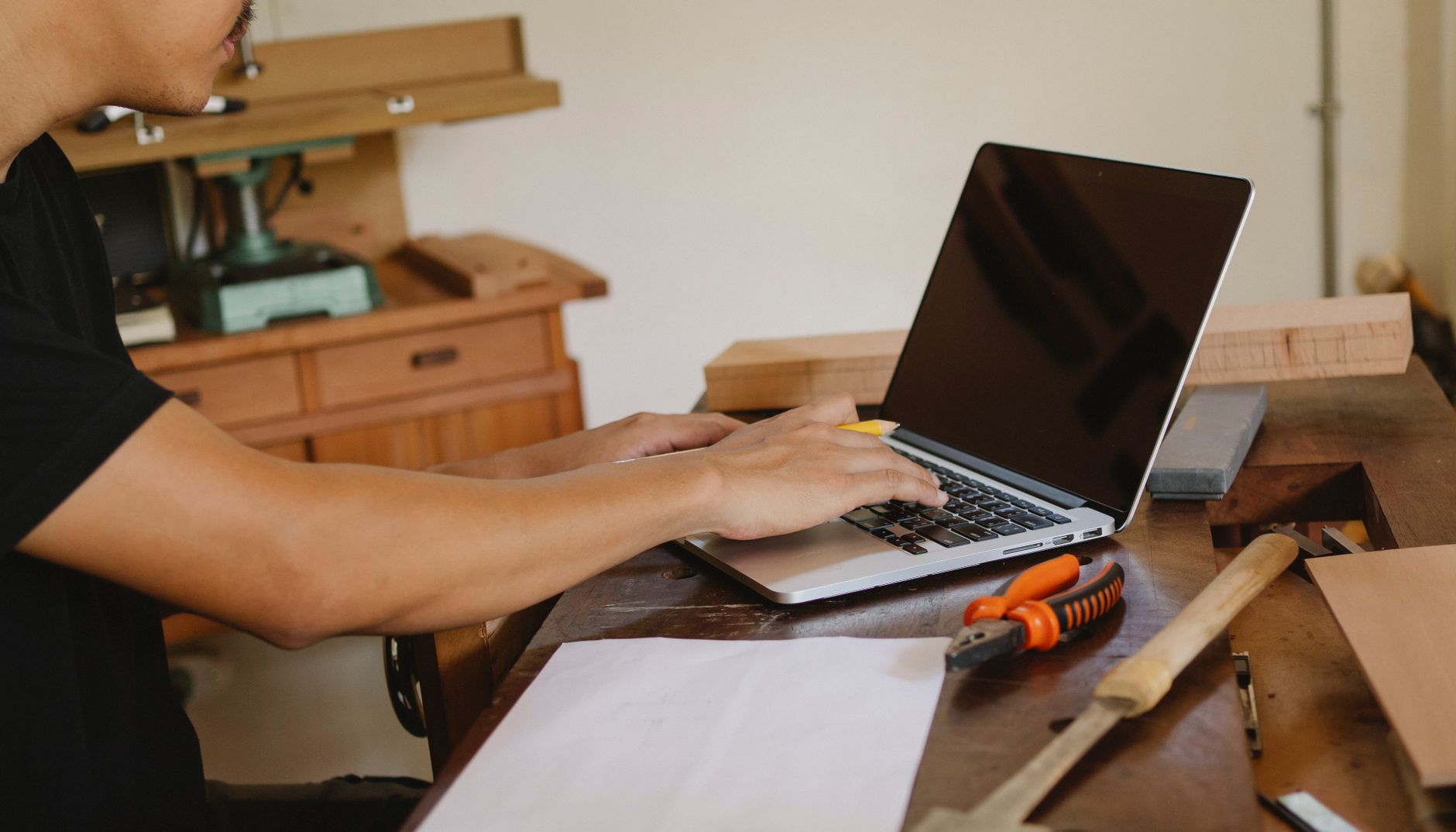 Small business owner working on a laptop, representing AI tools for small business.