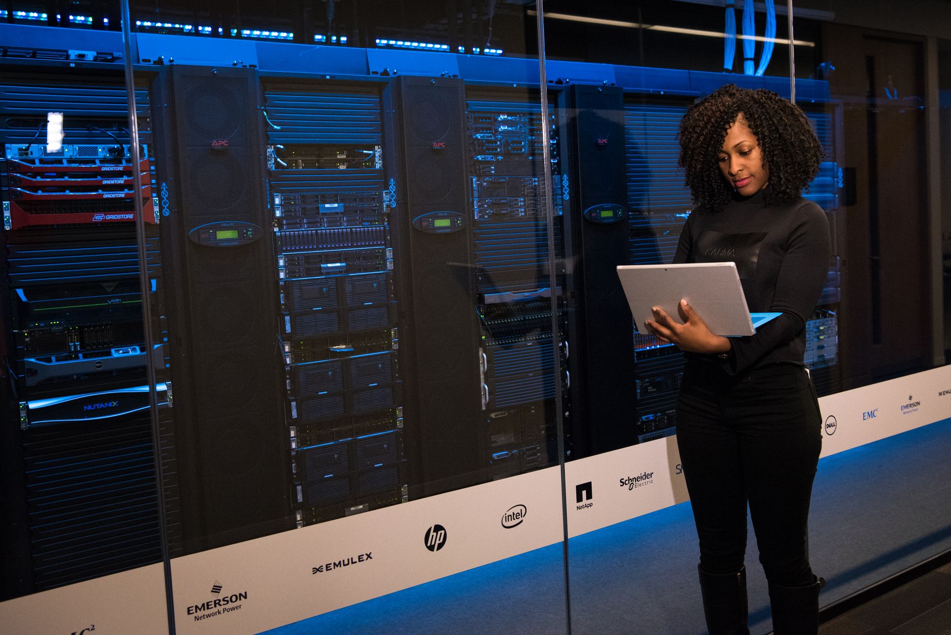 Security engineer monitoring network infrastructure on a laptop.