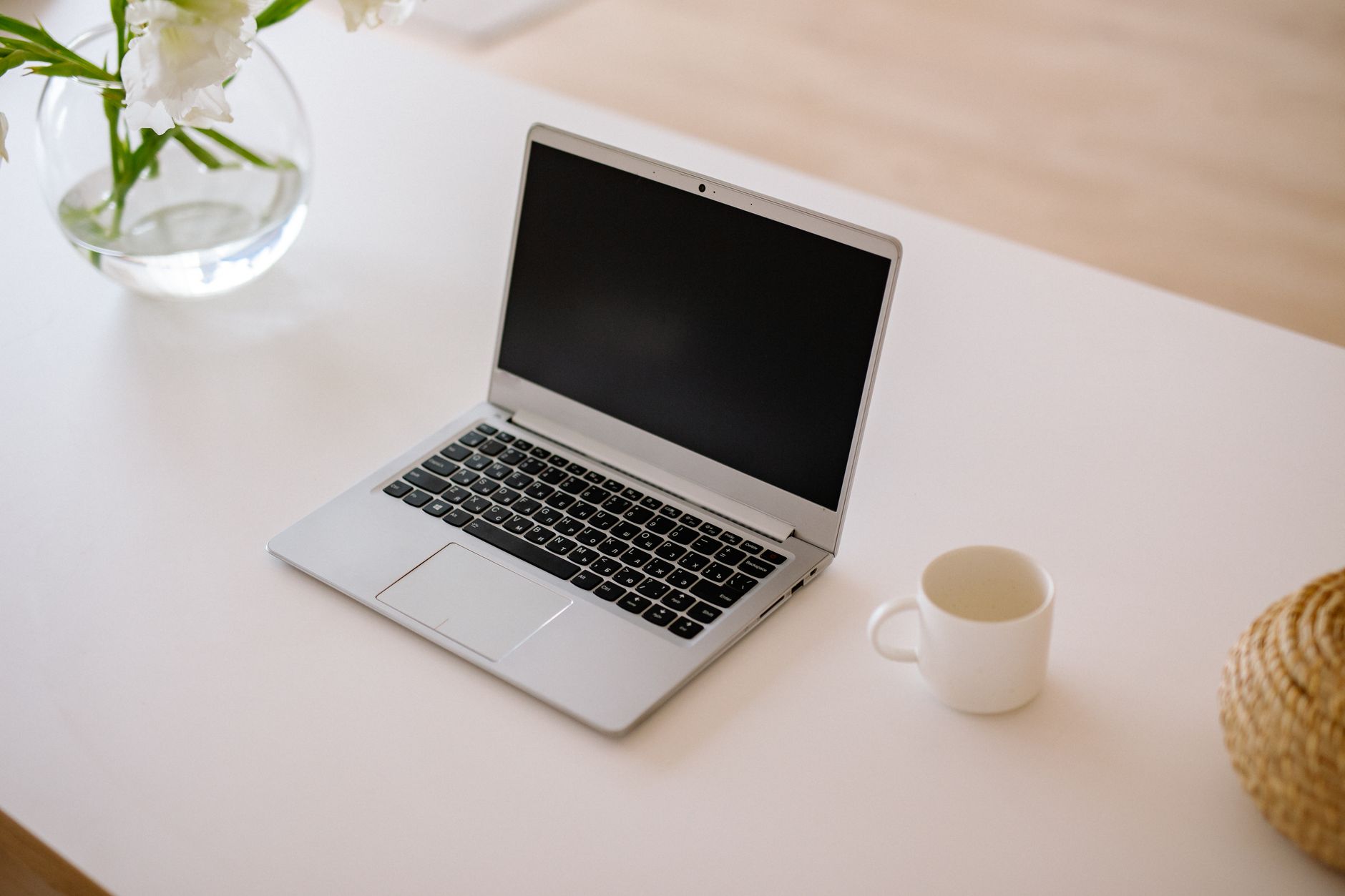 Silver laptop on a white desk representing AI agent tools