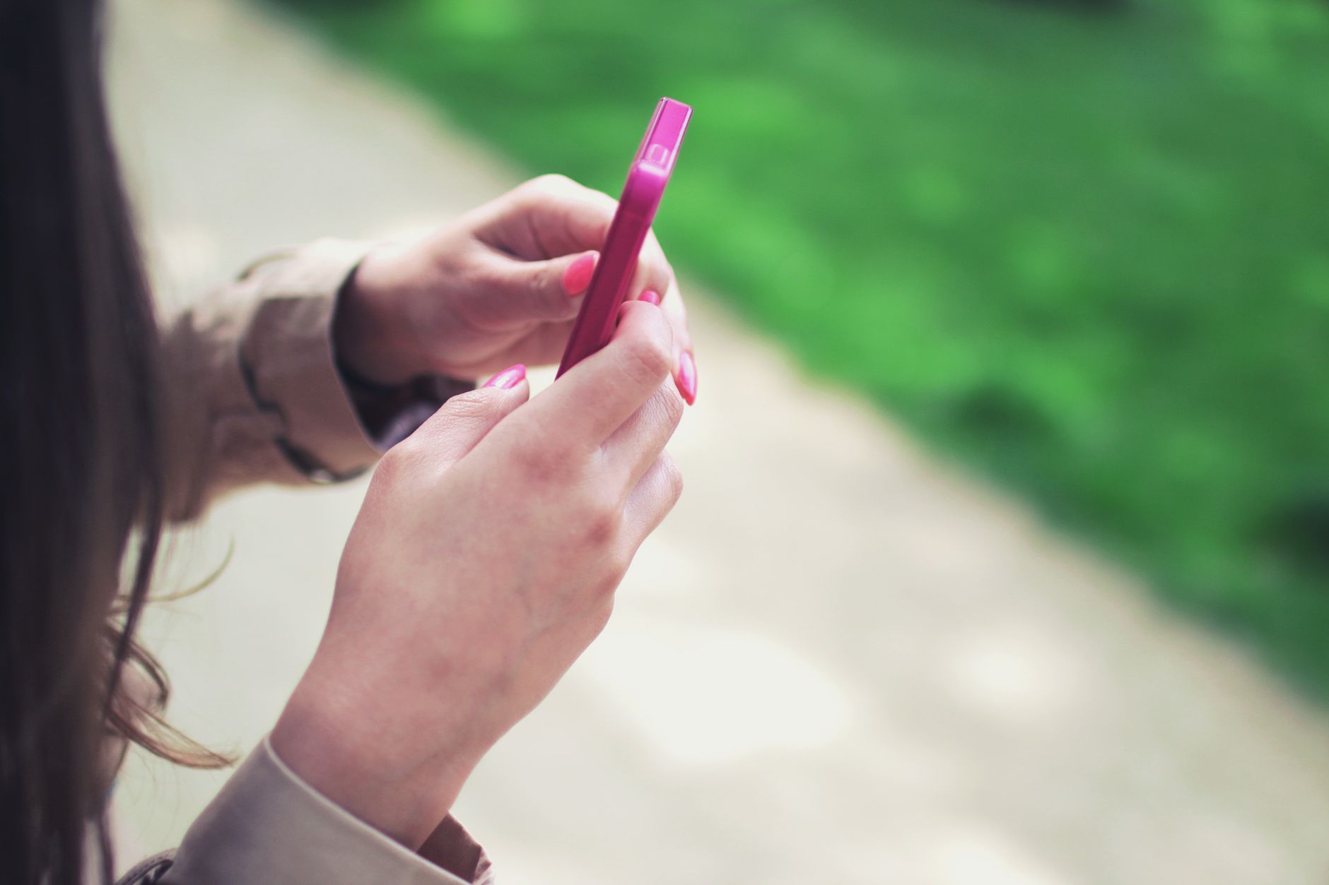 Person texting on a smartphone, representing OpenAI's new Dots texting feature